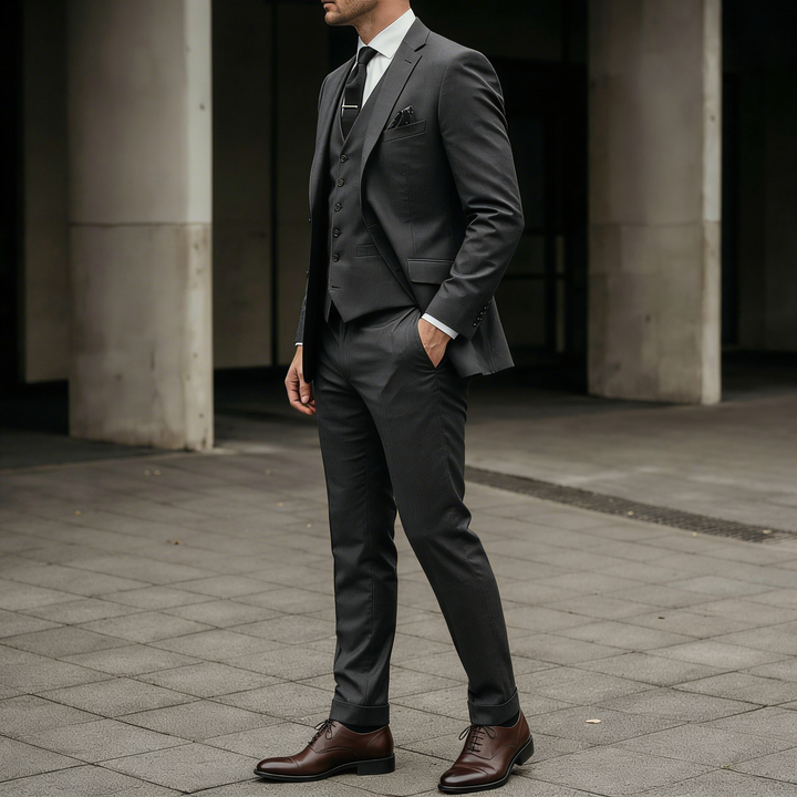 Charcoal grey tailored three-piece suit in a clean formal style