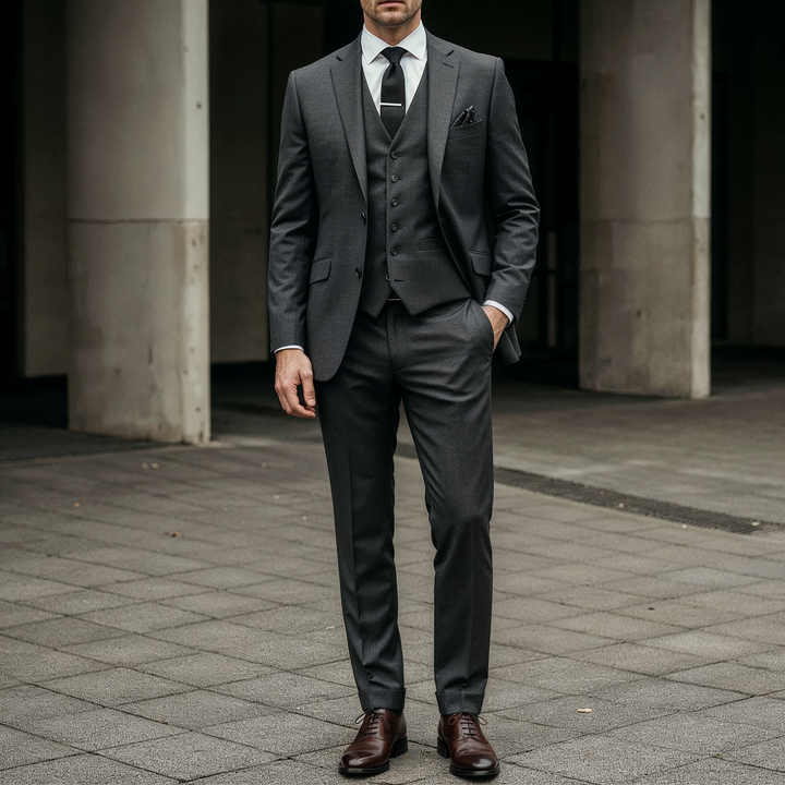 Charcoal grey tailored three-piece suit in a clean formal style
