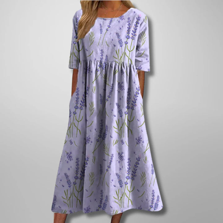 Sukienka letnia midi z okrągłym dekoltem i zwiewnym dołem, wzór kwiatowy na granatowym tle